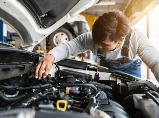 Certified Chevrolet technician inspecting vehicle maintenance