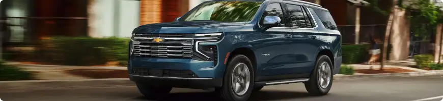Chevrolet Tahoe and Suburban towing a boat with the family aboard