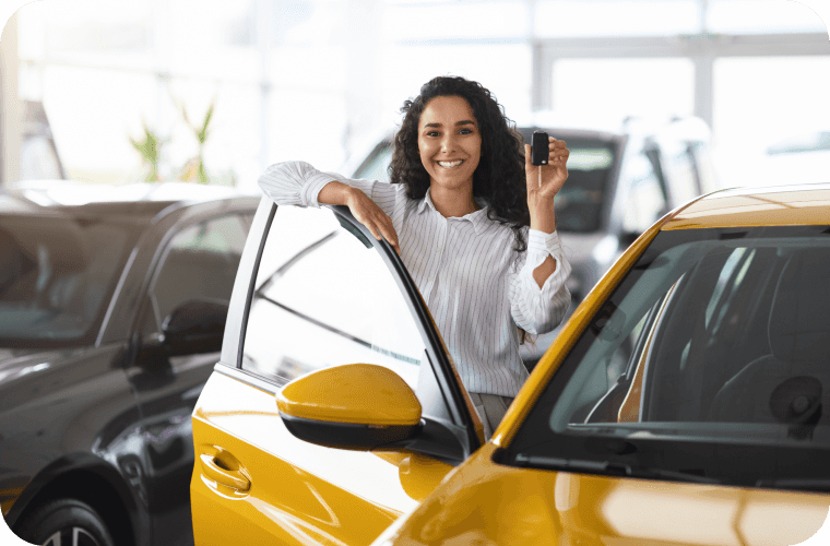 Lady presenting her new set of keys about to get into her new car