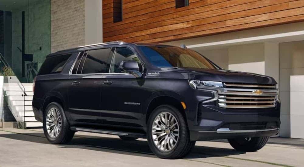 A blue 2023 Chevy Suburban High Country parked on a driveway.