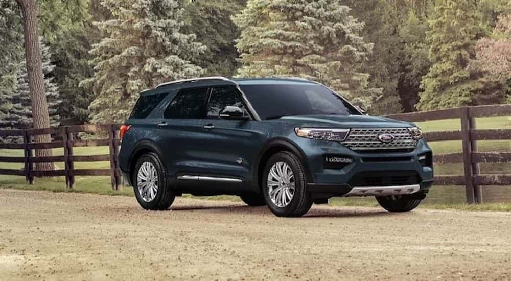 A green 2024 Ford Explorer King Ranch parked off-road.