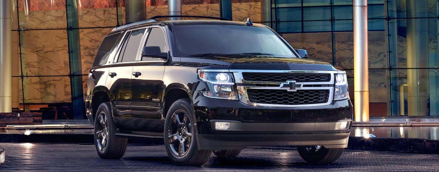 A black 2017 Chevy Tahoe parked in a city.