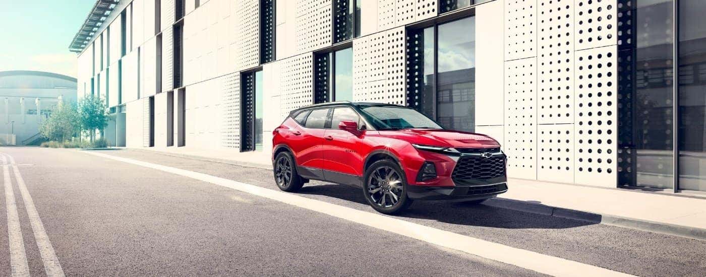 A red 2023 Chevy Blazer parked on a sunny city street