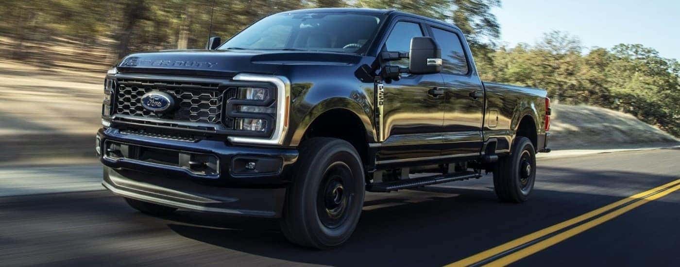 Black 2023 Ford F-250 STX driving to a Used Car Dealership in Roanoke
