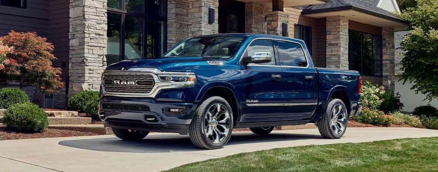 Blue 2023 Ram 1500 Limited Elite parked on a driveway.