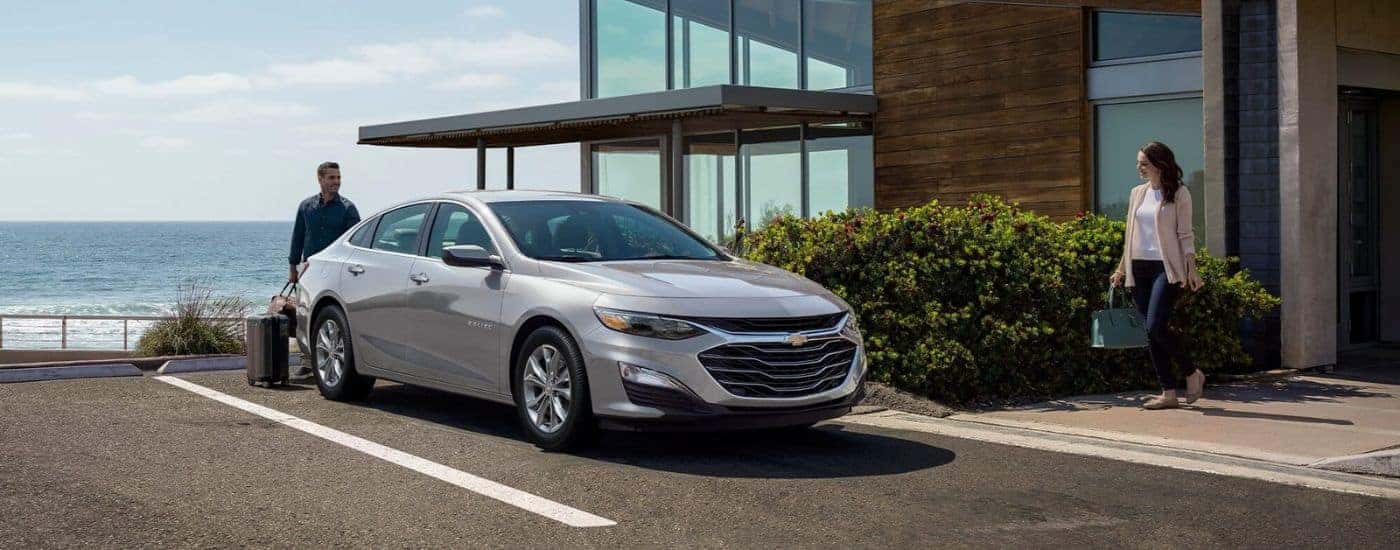 Silver 2024 Chevy Malibu parked near a house