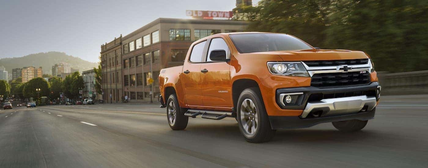 Orange 2021 Chevy Colorado Z71 driving in a city