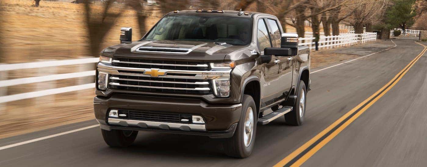 Brown 2020 Chevy Silverado 2500HD driving on a highway