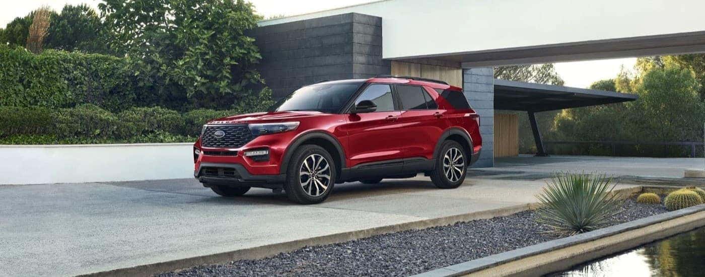 A red 2023 Ford Explorer ST Line parked in a modern home driveway