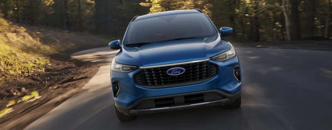 A blue 2023 Ford Escape shown driving from the front.
