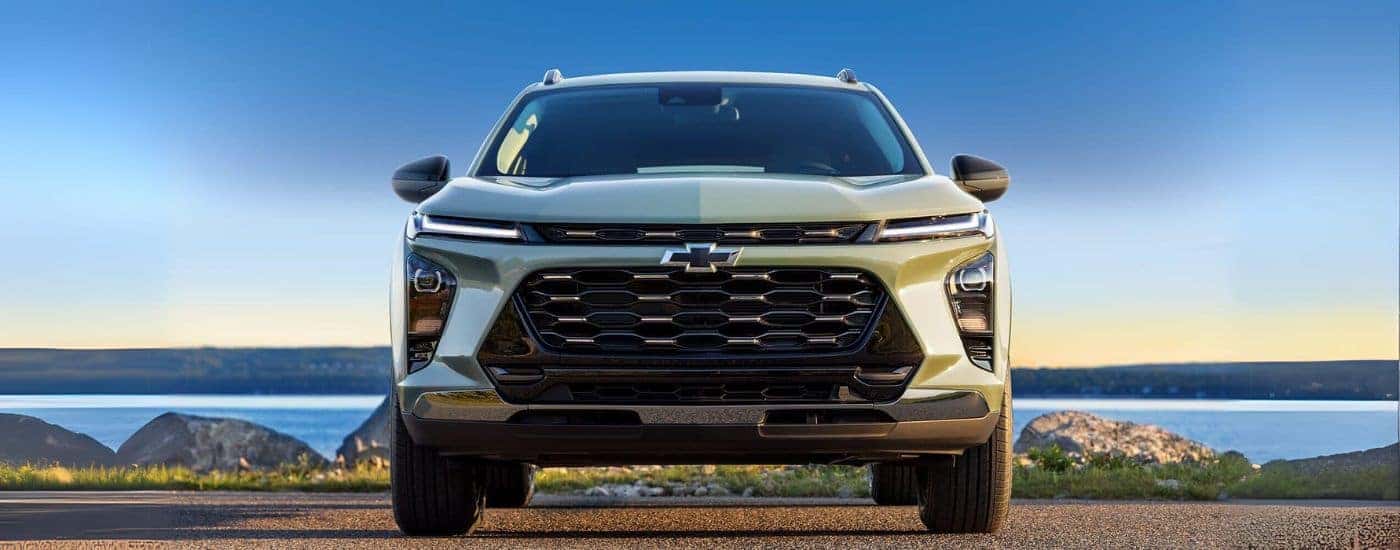 Green 2024 Chevy Trax parked in front of a lake