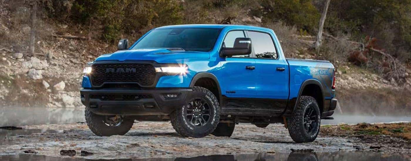 Blue 2026 Ram 1500 Rebel parked on a river bed