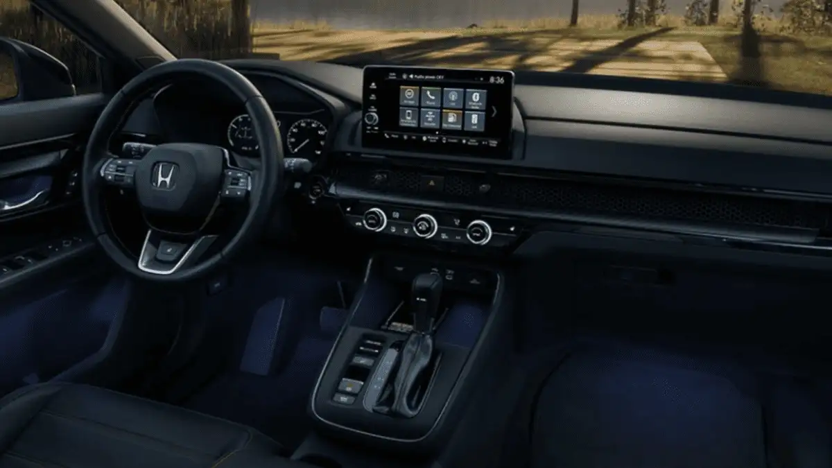 2026 Honda CR-V Hybrid near Smithtown, NY, wide front cabin view with steering wheel, touchscreen, climate controls, and center console