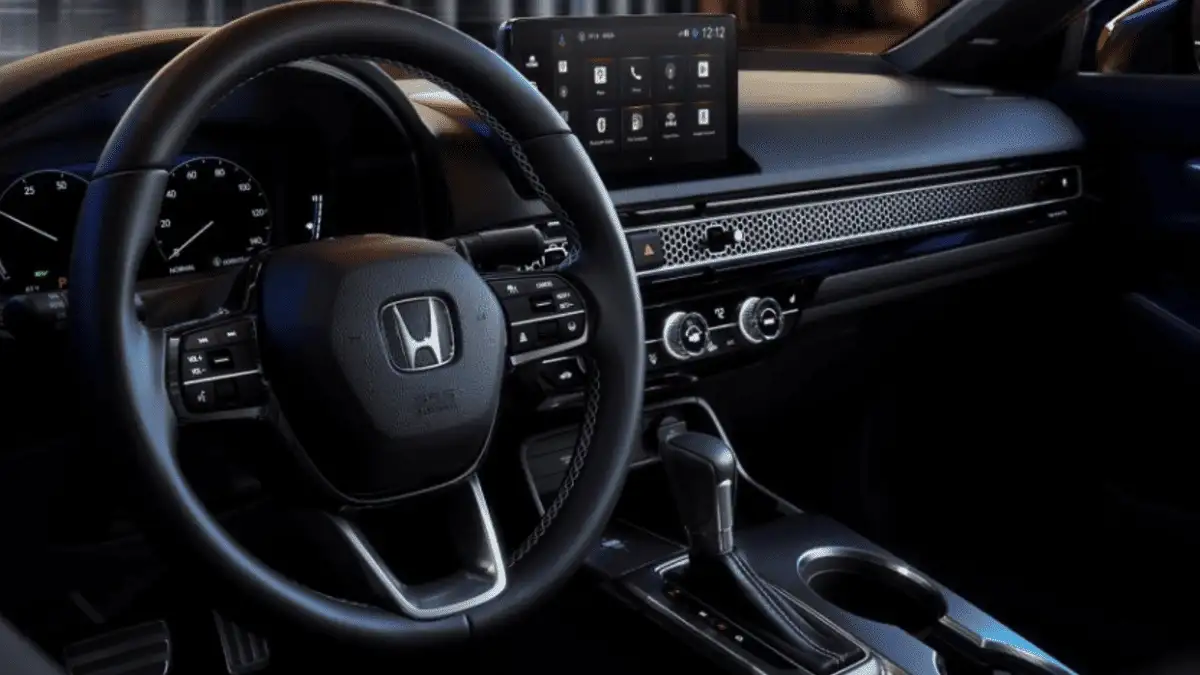 2026 Honda Civic Sedan near Smithtown, NY, driver cockpit close up with steering wheel controls, touchscreen display, and climate controls