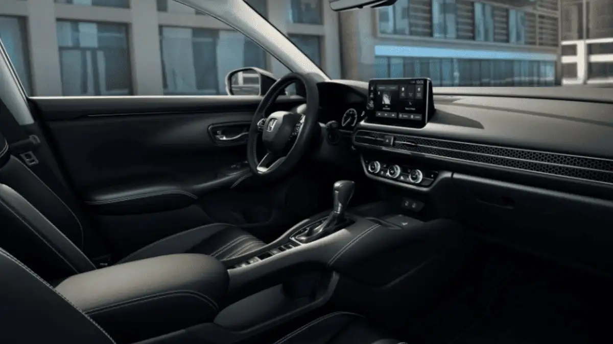 2026 Honda HR-V near Smithtown, NY, interior dashboard view with touchscreen infotainment, steering wheel, and modern city buildings outside