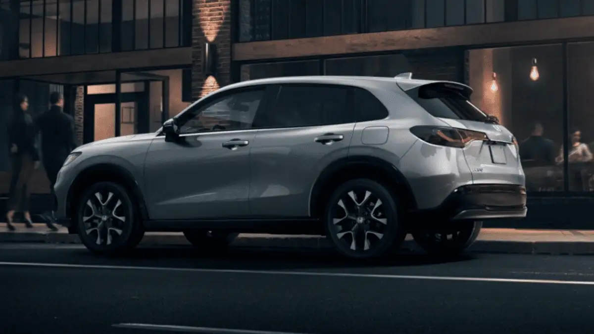 2026 Honda HR-V near Smithtown, NY, side profile parked curbside outside a modern building at night with city lights