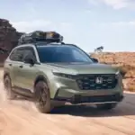 2026 Honda CR-V near Smithtown NY driving on a dusty road with roof rack, rugged SUV look for daily use comparisons