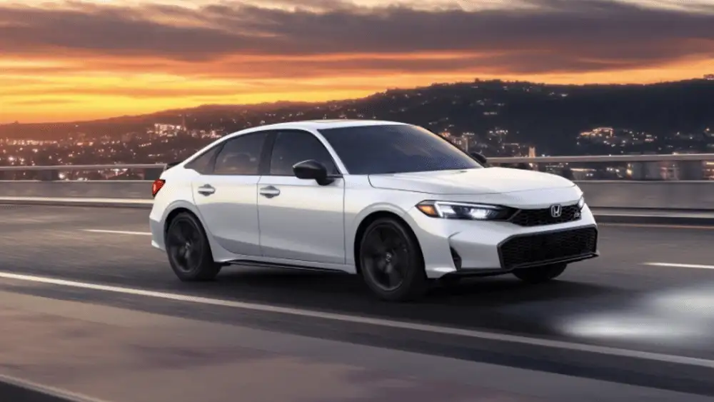 2026 Honda Civic Si near Smithtown, NY white sedan driving at sunset, exterior front angle on the road.