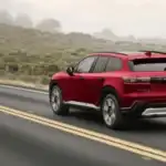 2026 Honda Prologue near Smithtown, NY shown from the rear on a scenic road, highlighting a modern electric SUV design for family travel.