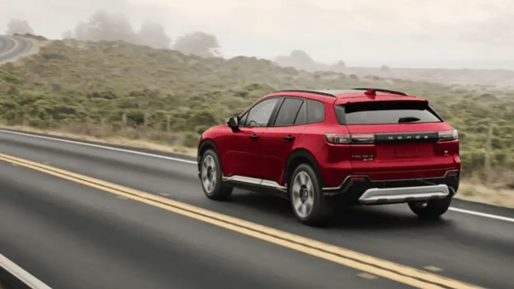 2026 Honda Prologue near Smithtown, NY shown from the rear on a scenic road, highlighting a modern electric SUV design for family travel.