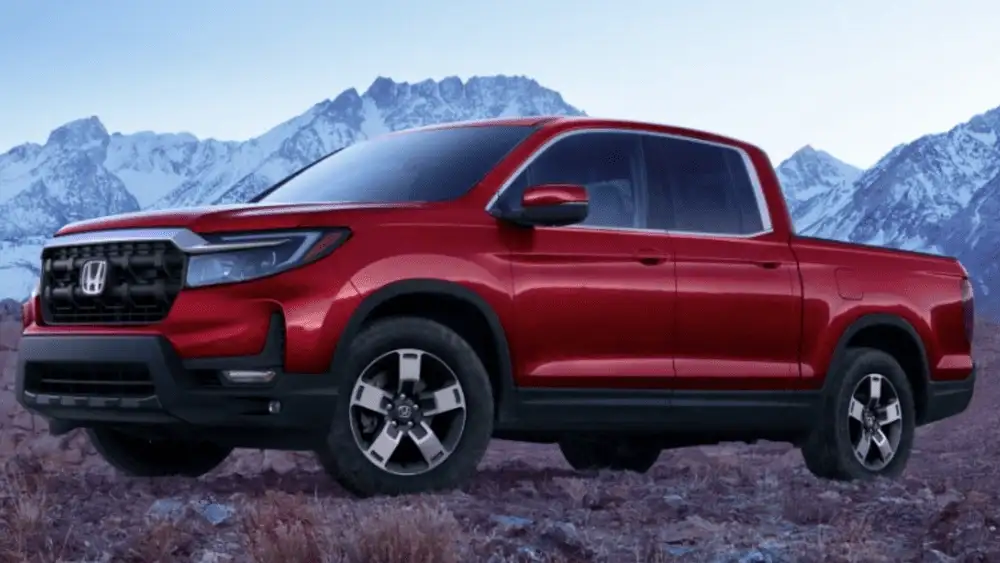 2026 Honda Ridgeline near Smithtown, NY red pickup shown in profile with a rugged look against a mountain backdrop