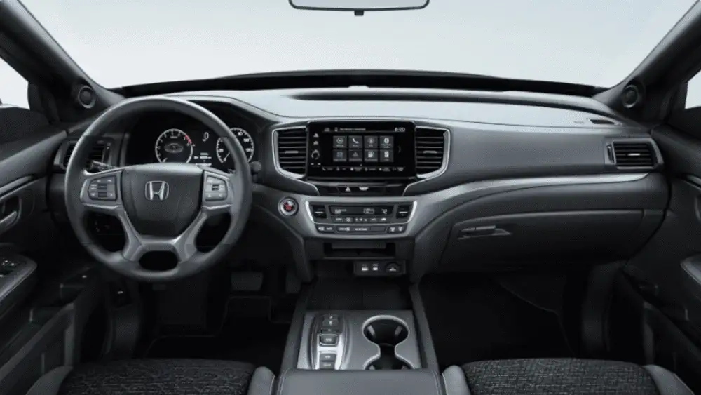 2026 Honda Ridgeline near Smithtown, NY dashboard and front cabin with touchscreen display, climate controls, and console storage