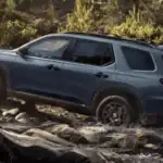 2025 Honda Pilot near Smithtown, NY driving on the road, showing a roomy family SUV with a clean rear view.