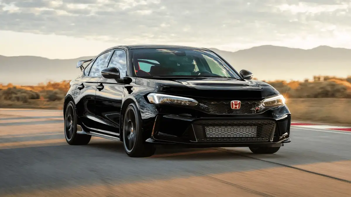 2025 Honda Civic Type R near Smithtown, NY black hatchback on a track, front view highlighting aggressive grille and red Honda badge
