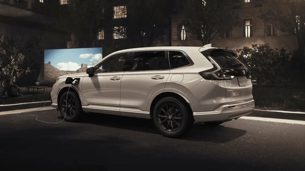 2026 Honda CR-V e:FCEV near Smithtown, NY white SUV plugged in and charging at night, side view with charging cable
