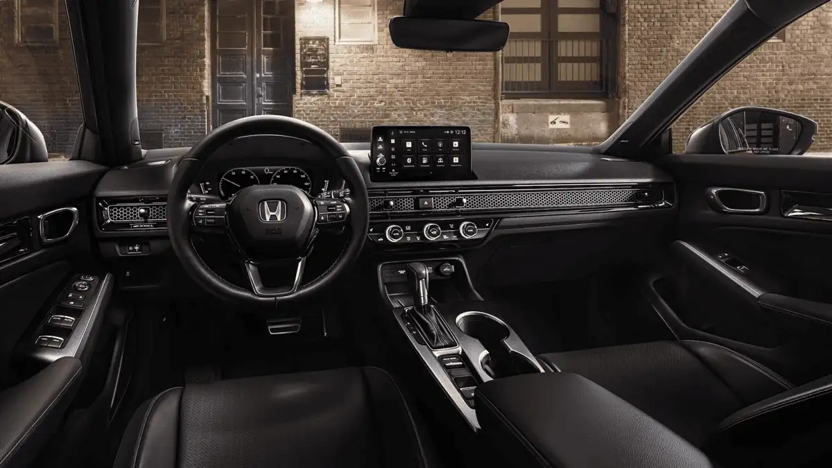 2026 Honda Civic Hatchback Hybrid near Smithtown, NY interior wide shot with touchscreen, steering wheel, and clean dashboard layout