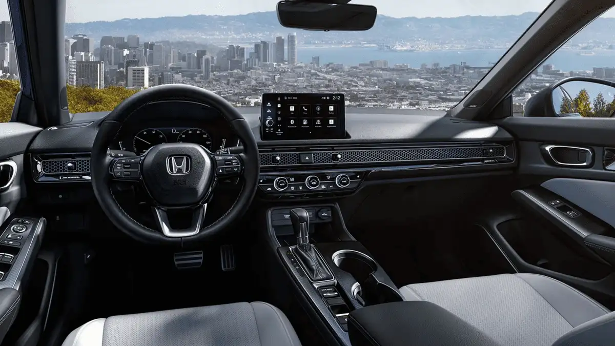 2026 Honda Civic Sedan Hybrid near Smithtown, NY front cabin view with touchscreen infotainment and city skyline in the background