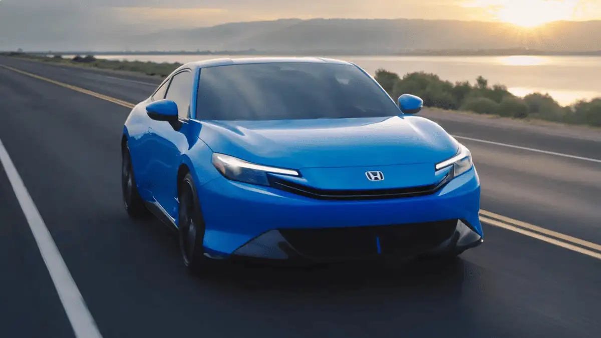 2026 Honda Prelude Hybrid near Smithtown, NY blue coupe driving on an open highway at sunset, front angle showing sleek styling