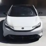 2026 Honda Prelude Hybrid near Smithtown NY shown from the front with sleek headlights and coupe styling on a clean, modern backdrop