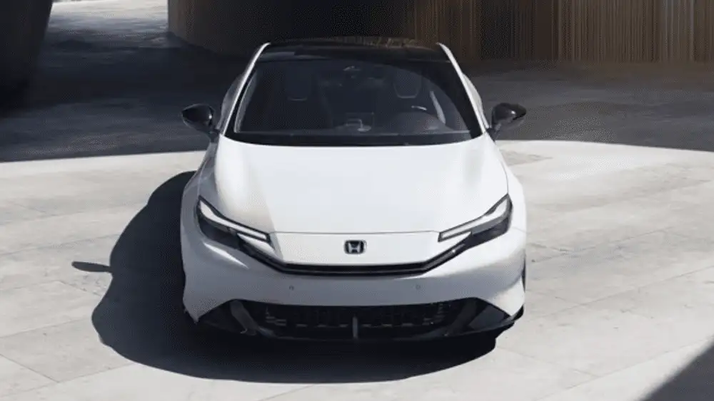 2026 Honda Prelude Hybrid near Smithtown NY shown from the front with sleek headlights and coupe styling on a clean, modern backdrop