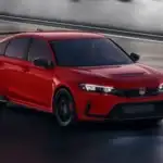 2025 Honda Civic Type R near Smithtown NY red performance hatchback driving on a track, showing aggressive front styling and aero wing