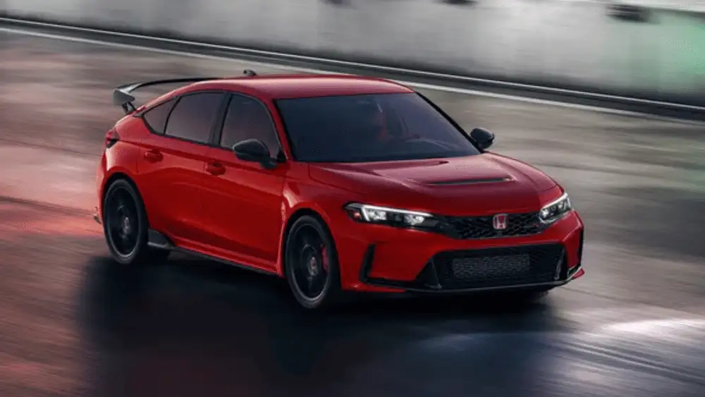 2025 Honda Civic Type R near Smithtown NY red performance hatchback driving on a track, showing aggressive front styling and aero wing