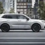 2026 Honda CR-V e:FCEV for Smithtown NY commuters shown in side profile on city streets, highlighting a clean white SUV design