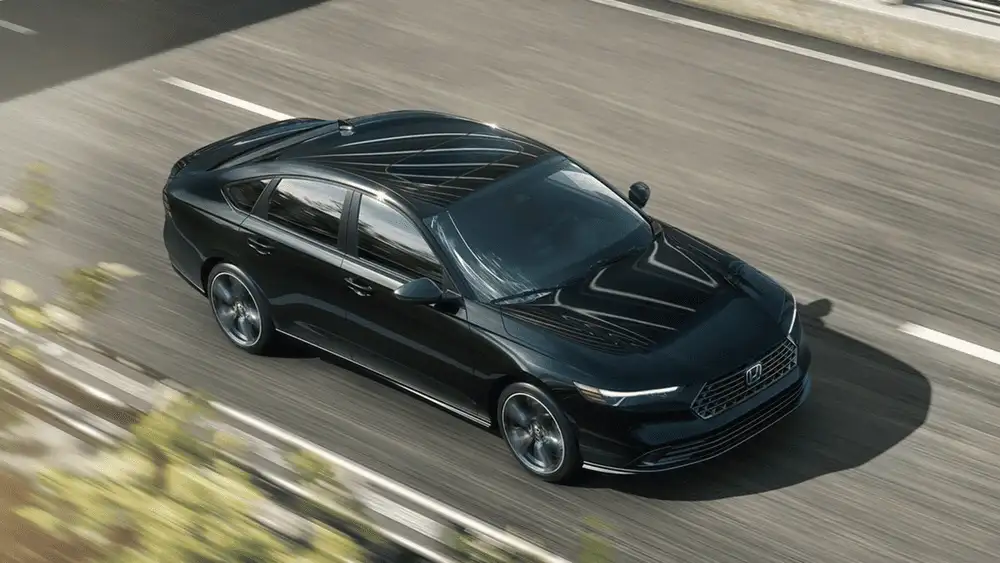 2026 Honda Accord Hybrid in Meteorite Gray Metallic aerial view driving on open road near Commack NY