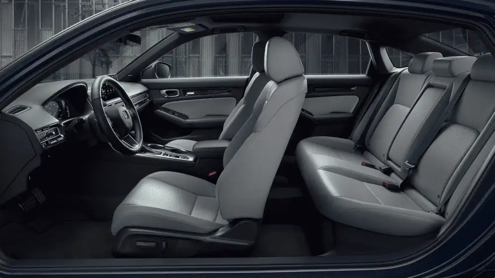 2026 Honda Civic Sedan interior side view showing gray leather front and rear seats near Commack NY