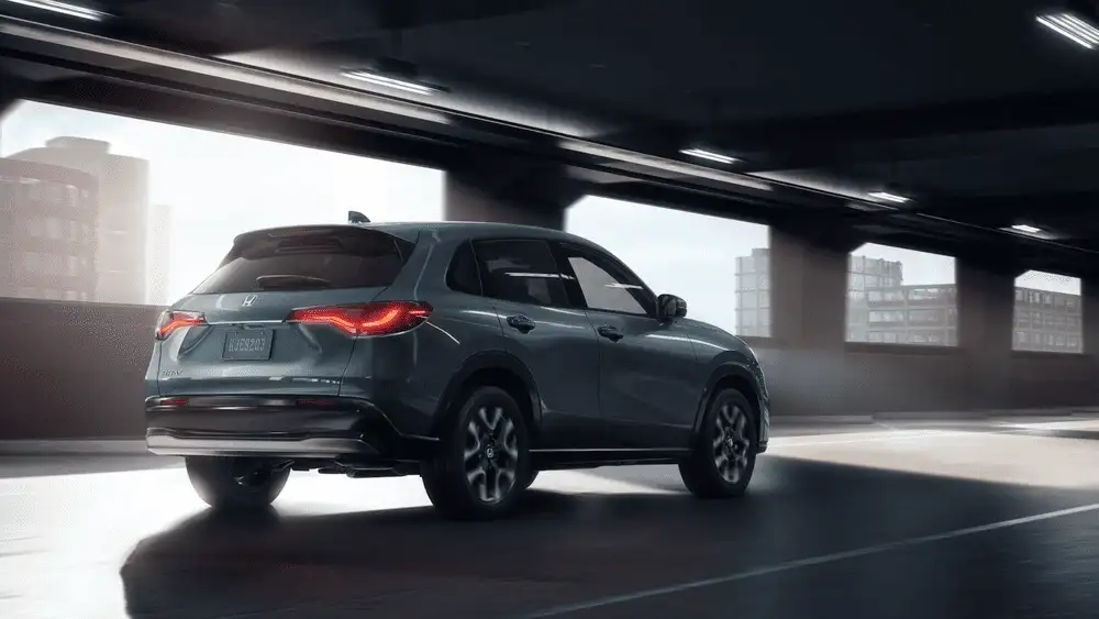 2026 Honda HR-V gray SUV rear three-quarter view driving under urban overpass near Commack NY