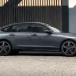 2026 Honda Accord Hybrid in Sonic Gray Pearl side profile parked on cobblestone — efficient earnings for rideshare drivers near Commack NY
