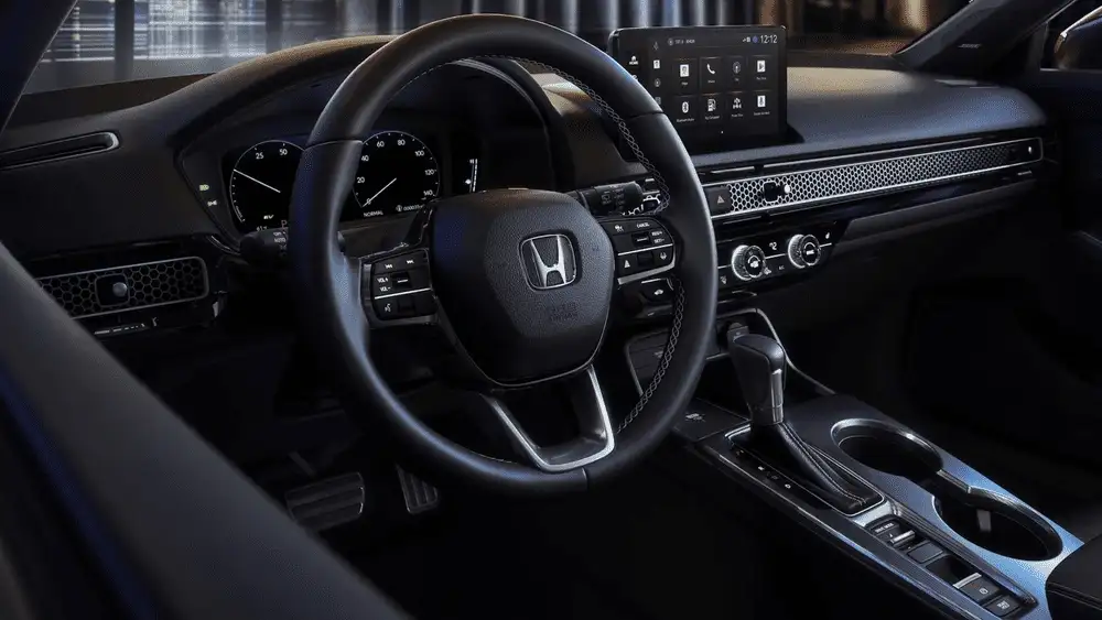 2026 Honda Civic Hatchback interior cockpit with Honda steering wheel and touchscreen display near Commack NY