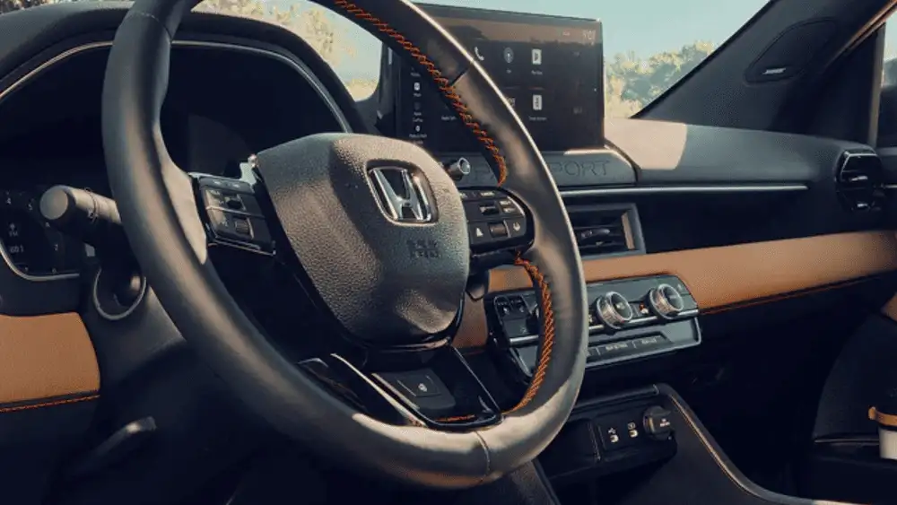 2026 Honda Passport TrailSport interior steering wheel with orange stitching and touchscreen display near Commack NY