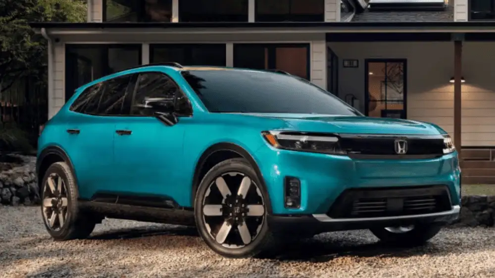 2026 Honda Prologue electric SUV in Aegean Blue front three-quarter view parked outside home near Commack NY
