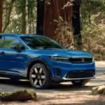 2026 Honda Prologue electric SUV in blue parked in forest while group relaxes nearby — charging around Commack NY made simple