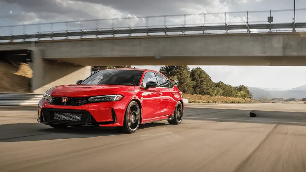 2025 Honda Civic Type R in Championship Red front three-quarter view driving on race track