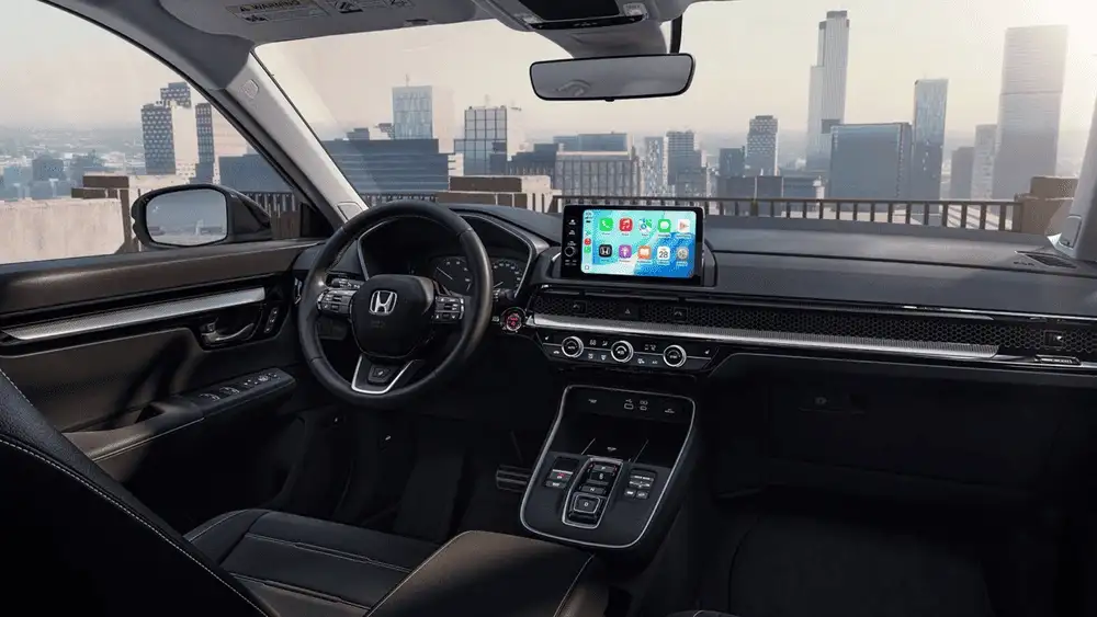 2026 Honda CR-V e:FCEV interior dashboard with Honda steering wheel and Apple CarPlay touchscreen near city skyline