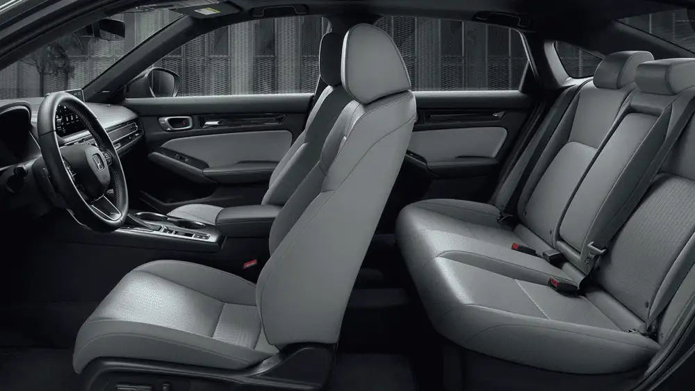 2026 Honda Civic Sedan Hybrid gray cloth front and rear seat interior side view with steering wheel visible