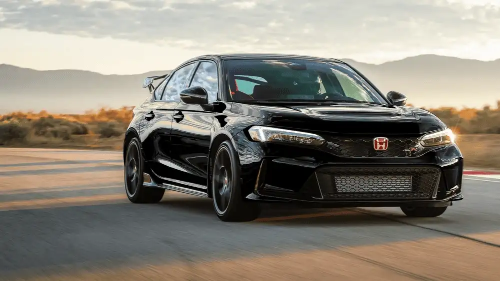 Black 2025 Honda Civic Type R speeding down a desert track at sunset, built for turbocharged fun for Commack drivers