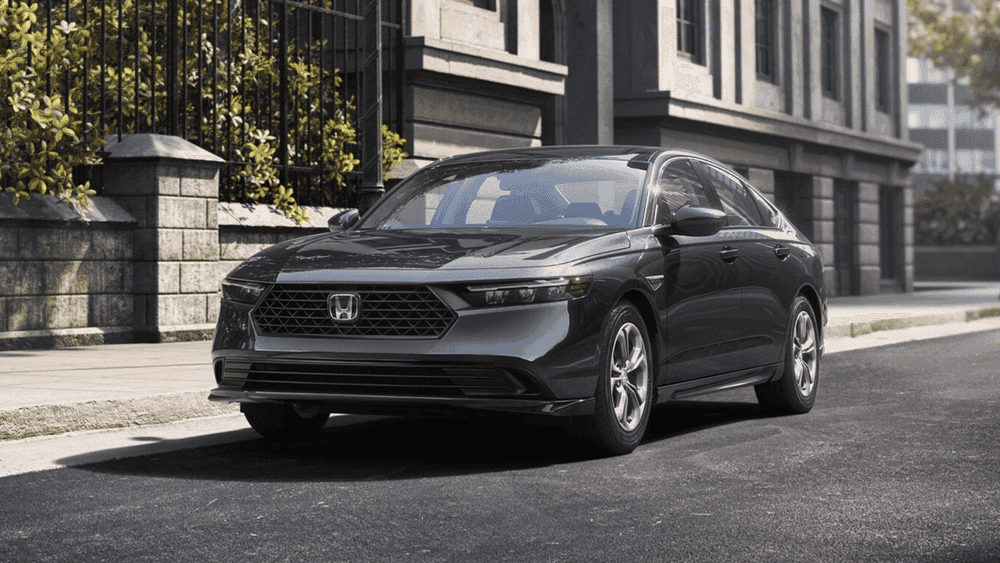 Dark gray 2026 Honda Accord parked on a city street near a classic building near Hauppauge NY